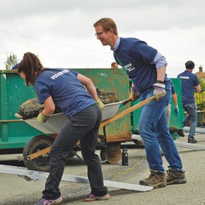 Congressman Derek Kilmer Assists with a heavy load of asphalt at the Holy Rosary Depave project